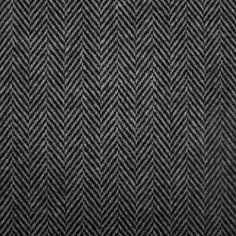 an upholstered black and white herringle fabric with small, diagonal patterns on it