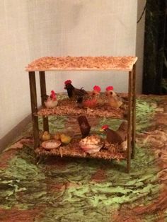 there is a small table with chickens in it on the floor next to a wall