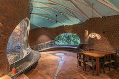 an indoor dining area with brick walls and arched windows