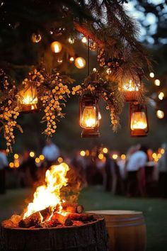 A fall wedding garden setup featuring glowing lanterns hanging from trees and a warm bonfire, creating a cozy and intimate atmosphere for an October wedding. Simple Intimate Wedding Ideas, Wedding Bonfire, Fall Smores, Decor With Lanterns, Cozy Fall Wedding, Bonfire Wedding, Cozy Wedding