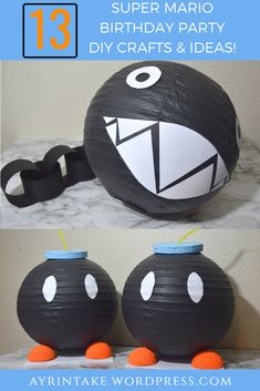 two black and white paper lanterns with faces on them, one has an orange nose