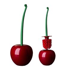 two red apples with green stems sticking out of them