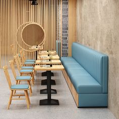 an empty restaurant with blue benches and wooden tables