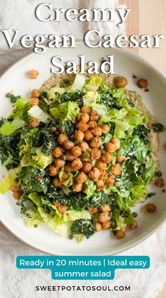 a white plate topped with lettuce and chickpeas