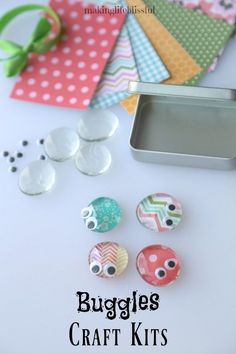 some buttons are sitting on a table next to a cookie tin and other crafting supplies