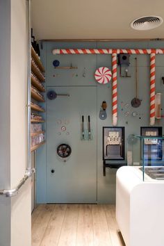 the inside of a store with candy canes and other items on the wall behind it