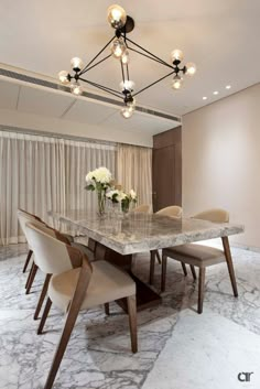 an elegant dining room with marble table and chairs