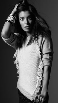 a young woman is posing for a black and white photo