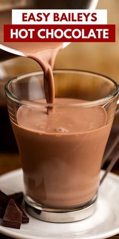 chocolate being poured into a glass cup with the words easy bailey's hot chocolate