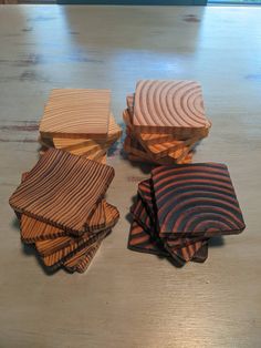 four wooden coasters stacked on top of each other