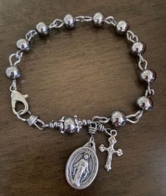 PLEASE CHECK OUT MY OTHER ROSARIES AND CHAPLETS AT: https://www.ebay.com/usr/ymrosaries Material: 8mm stainless steel beads 18 Gauge stainless steel wire 3/4" miraculous medal.  Length: Approx. 8-1/2" for a tighter fit you can hook the clasp on to any of the link.   100% LIFETIME GUARANTEE . if a rosary ever breaks, we will repair for FREE. IF YOU HAVE ANY QUESTIONS PLEASE ASK BEFORE YOU PURCHASE. Baroque Jewelry, Silver Rosary, Rosary Bracelet, Jewelry Accessories Ideas, Unusual Jewelry, Miraculous Medal, Funky Jewelry, Jewelry Lookbook, Stainless Steel Wire