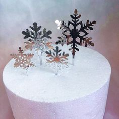 two snowflakes on top of a white cake