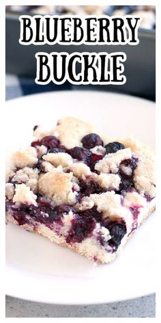 blueberry crumble bars on a white plate with the words, blueberry buckie