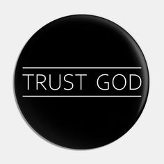 a black button with the words trust god on it