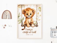 a baby lion is sitting on a swing with the words i am a child of god above it