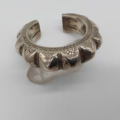 This vintage tribal cuff bracelet from Baluchistan has beautiful wear on it. The piece is hollow, so not terribly heavy Weighing 76.7 g.. The opening is a little over an inch wide and should fit most average size women. A beautiful piece to add to any collection. Heavy Bohemian Bangle Cuff Bracelet, Bohemian Heavy Cuff Bracelet For Ceremonial Use, Heavy Bohemian Cuff Bracelet For Ceremonial Occasions, Unique Heavy Bangle Bracelets, Unique Heavy Bangle Bracelet, Traditional Festival Cuff Bangle, Traditional Cuff Bangle For Festival, Antique Carved Cuff Bracelet Bangle, Bohemian Bangle Cuff Bracelet For Ceremonial Occasions