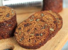 three muffins sitting on top of a wooden cutting board