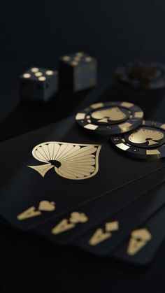 several black and gold playing cards on a table