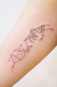 a woman's arm with a red line drawing on the left side of her leg