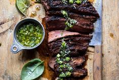 steak with salsa and limes on a cutting board