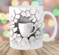 a white coffee mug with a hole in the middle on a wooden table next to a blurry background