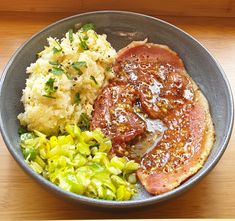 meat, mashed potatoes and vegetables in a bowl on a wooden table with text overlay