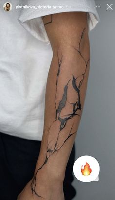 a person with a tattoo on their arm that is covered in black and white ink