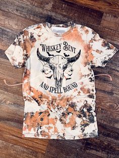 Loving these shirts, this season, all of it!!  Bleached cowhide design with Whiskey Bent and Spell Bound Graphic sublimated on it! LOVE IT! Gildan Heather gray  Bleached and sublimated  Bleach patterns will slightly vary due to hand bleaching !  Have a custom order ? Contact us we'd love to help! Bleach Tshirt Ideas, Distressed Tie-dye T-shirt For Fall, Distressed Tie Dye T-shirt For Fall, Acid Wash Skull Print Top For Halloween, Halloween Acid Wash Skull Print Top, Halloween Bleach Shirt Ideas, Popular Shirt Designs, Bleach Patterns, Shirt Transfers