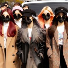 four mannequins wearing face masks in front of a car