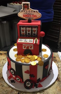 a cake made to look like a slot machine with gold coins on the front and sides