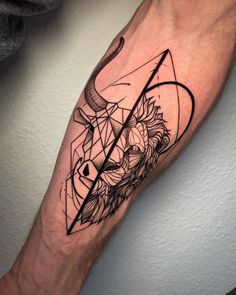 a man's arm with a bull and triangle tattoo on it