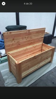 a large wooden box sitting on top of a tarp