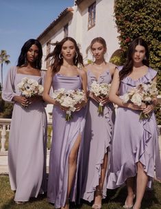 the bridesmaids are all dressed in lavender colored dresses and holding bouquets with white flowers