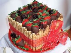 a cake with strawberries and chocolate covered strawberries