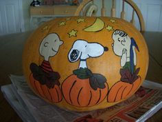 a pumpkin decorated with snoop and charlie brown on it