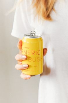 a woman holding a can of emeric bush