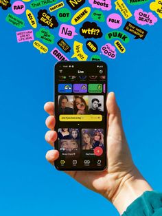 a person holding up a cell phone with many stickers on it's screen