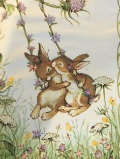 two rabbits sitting on top of each other in the middle of flowers and grass,