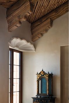 a room with a large mirror and wooden ceiling