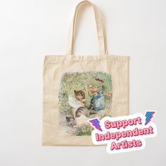 a tote bag with an image of two cats on it and the words support independent artists