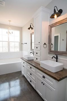 a bathroom with two sinks and a bathtub