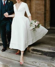 a bride and groom are walking down the steps