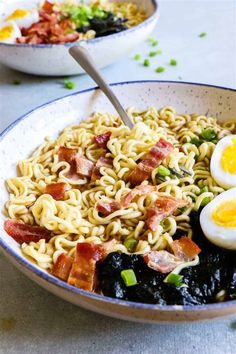 two bowls filled with noodles, bacon and eggs