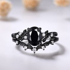 a black diamond ring sitting on top of a table