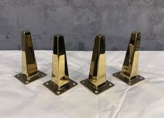 three brass plated bookends sitting on top of a white table