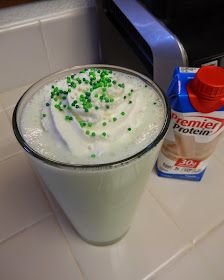 a drink with green sprinkles sitting on top of a counter