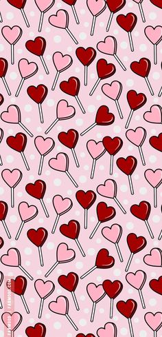 many hearts and lollipops on a pink background