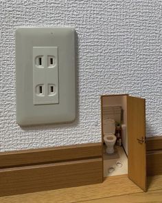 an electrical outlet with a toilet in it