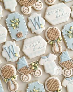 baby shower cookies decorated with blue and white icing are arranged on a table top