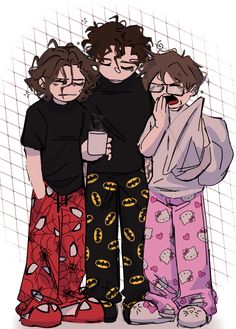 three people standing next to each other in pajamas